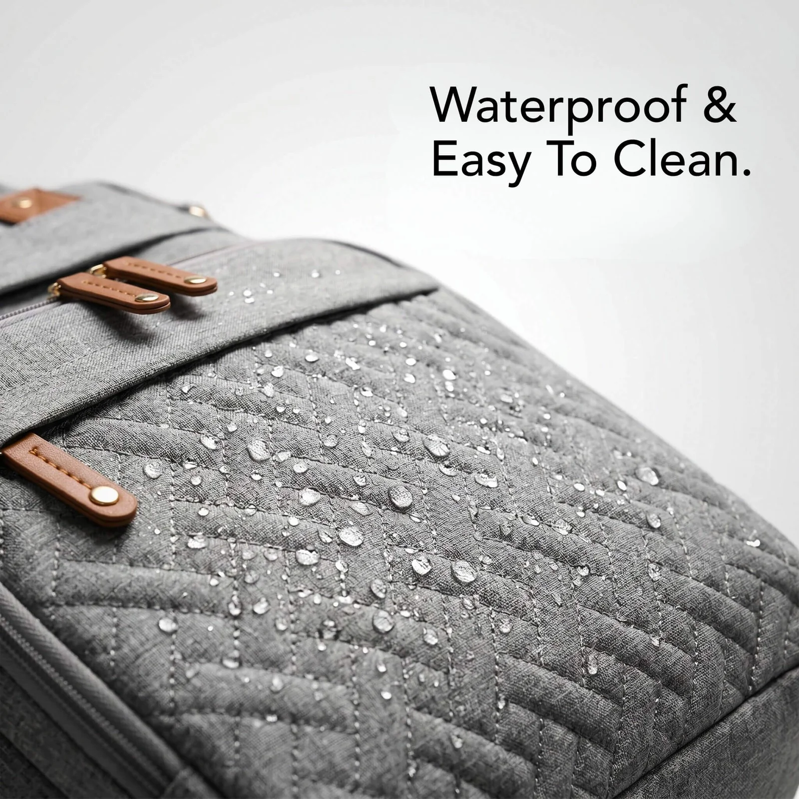 Close-up of the Nesti waterproof shell with water droplets beading on the fabric